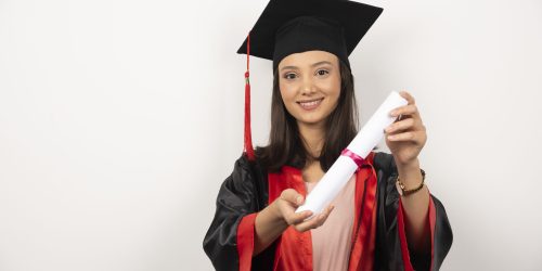 Graduate student showing her diploma on white background. High quality photo
